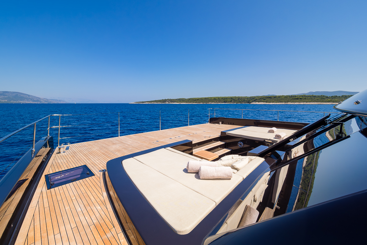 Amber One luxury catamaran - bow deck with integrated sunbeds and stairs for a lower deck.