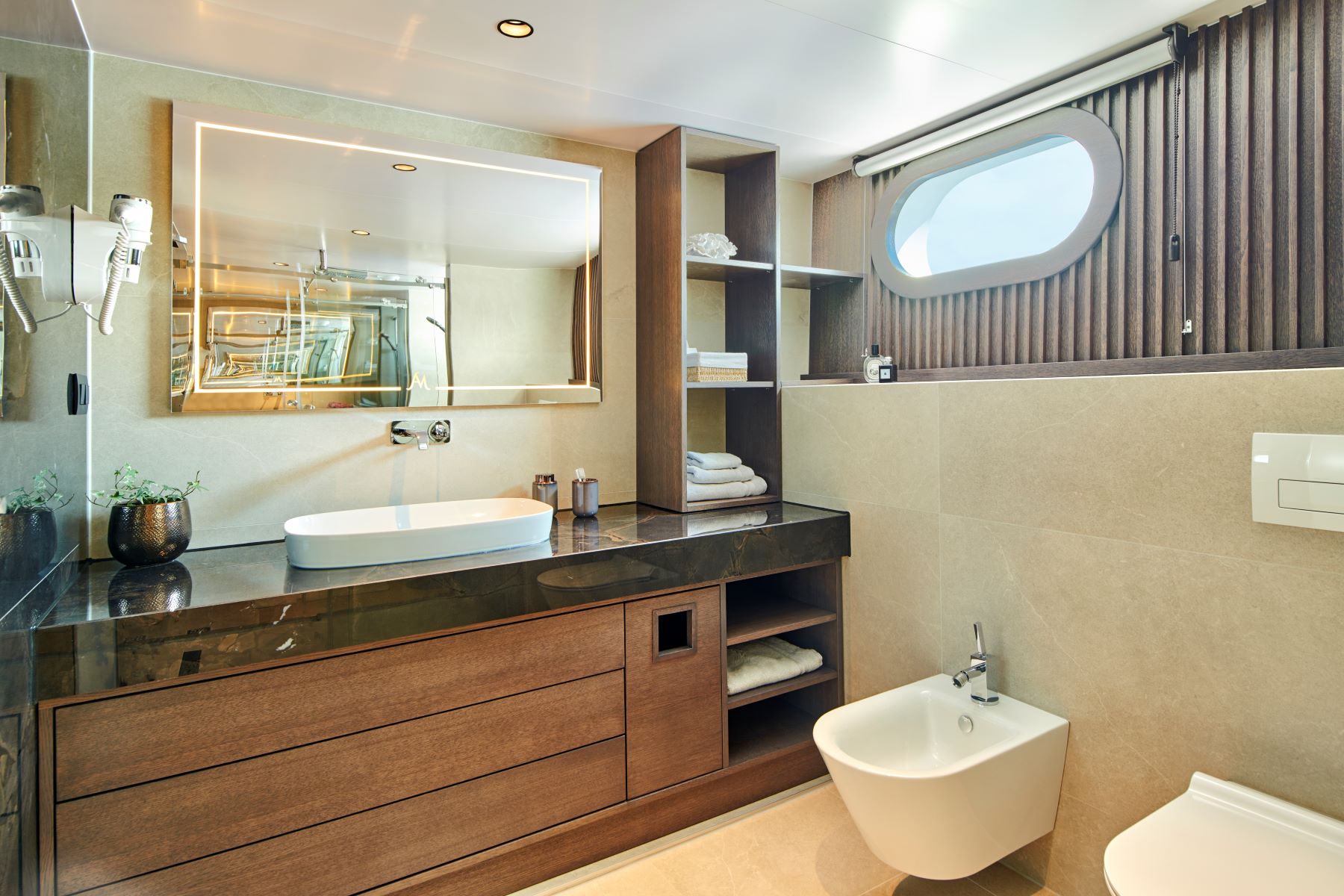 Anima Maris sailing yacht - small bathroom in a cabin with a big porthole.