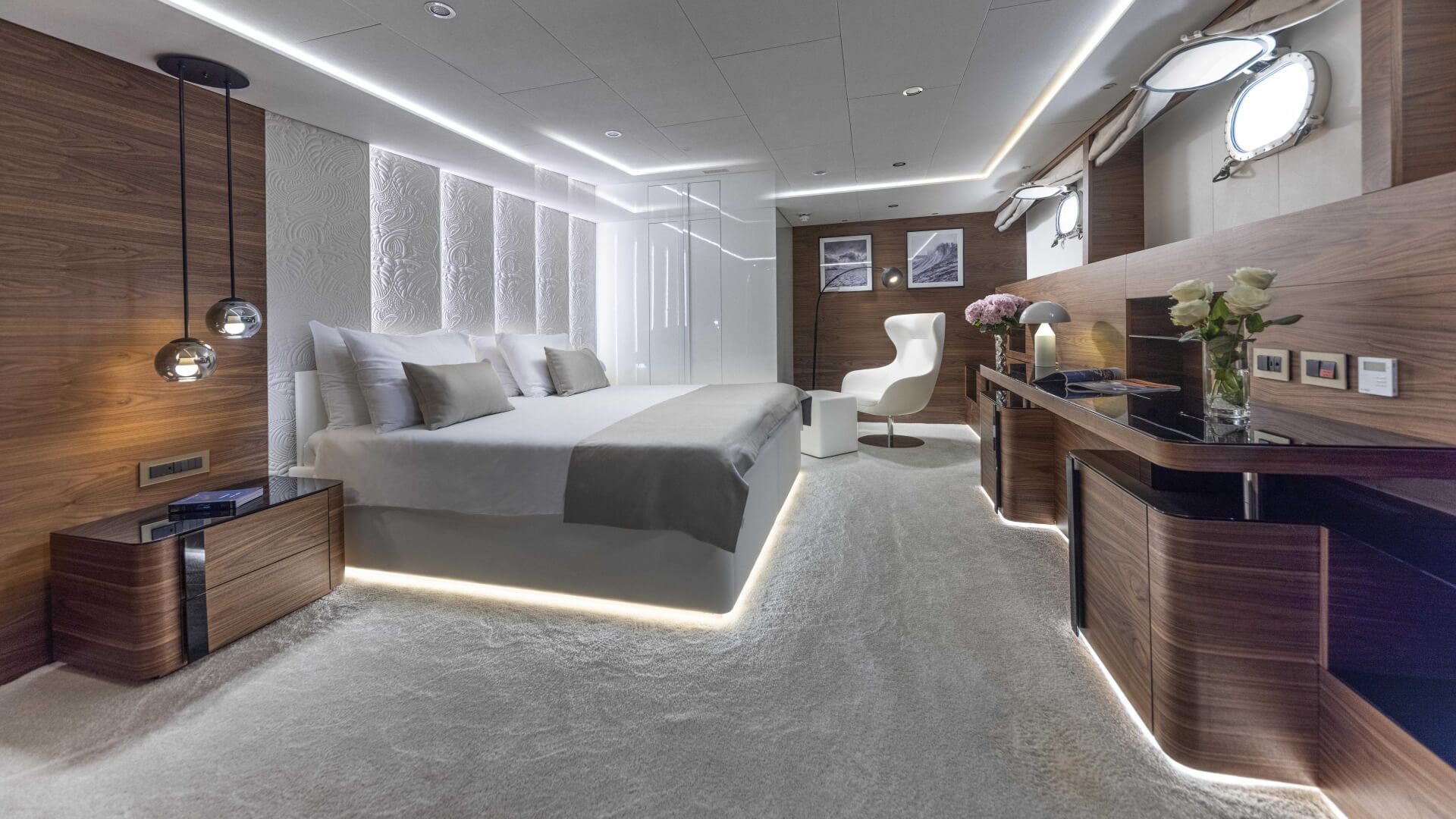 Anthea luxury yacht - cabin with a double bed, 2 portholes, a dressing table and a lounge area.