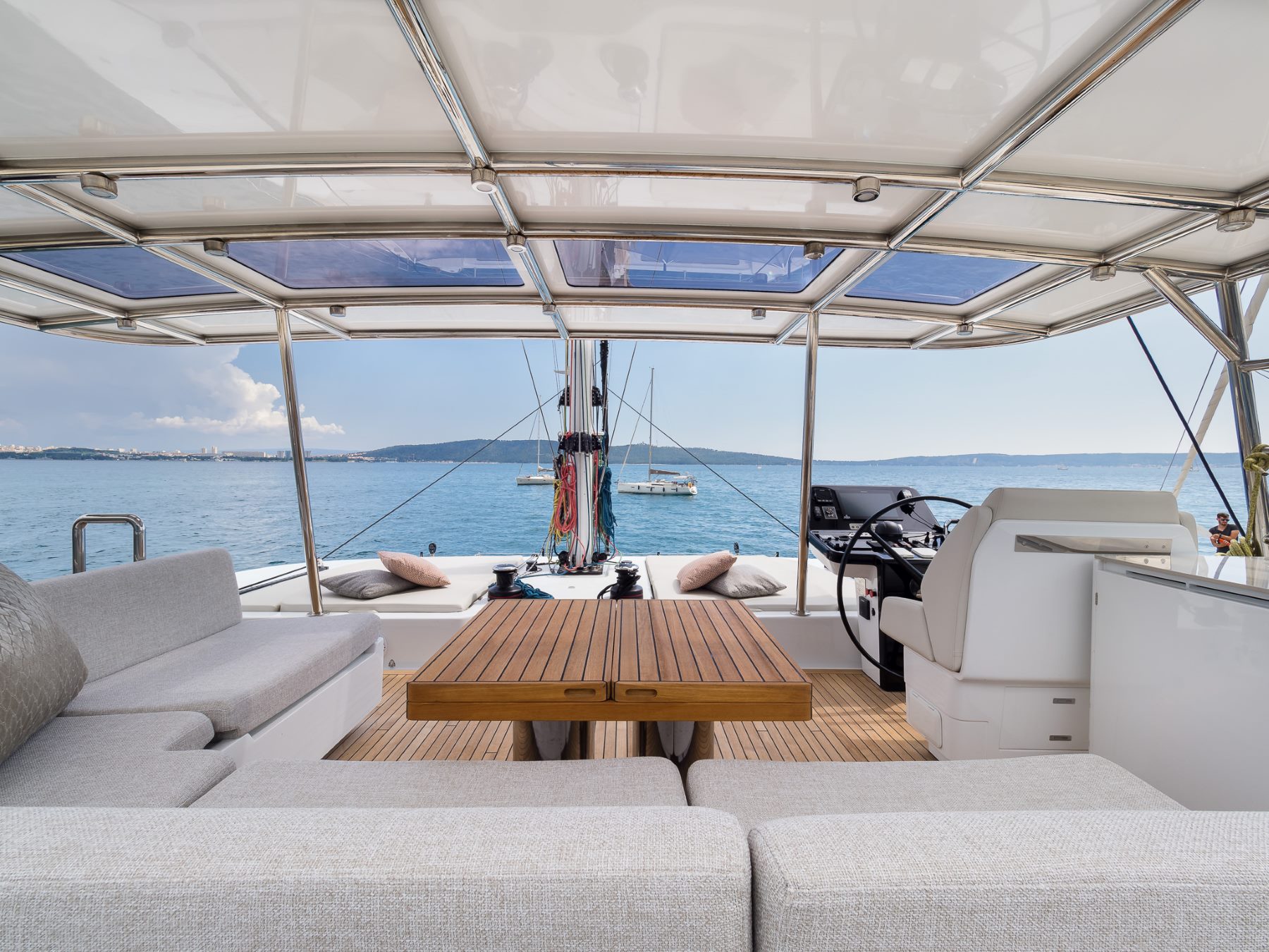 Sweet Dreams luxury yacht - upper deck covered lounge area with a command bridge with a helm.