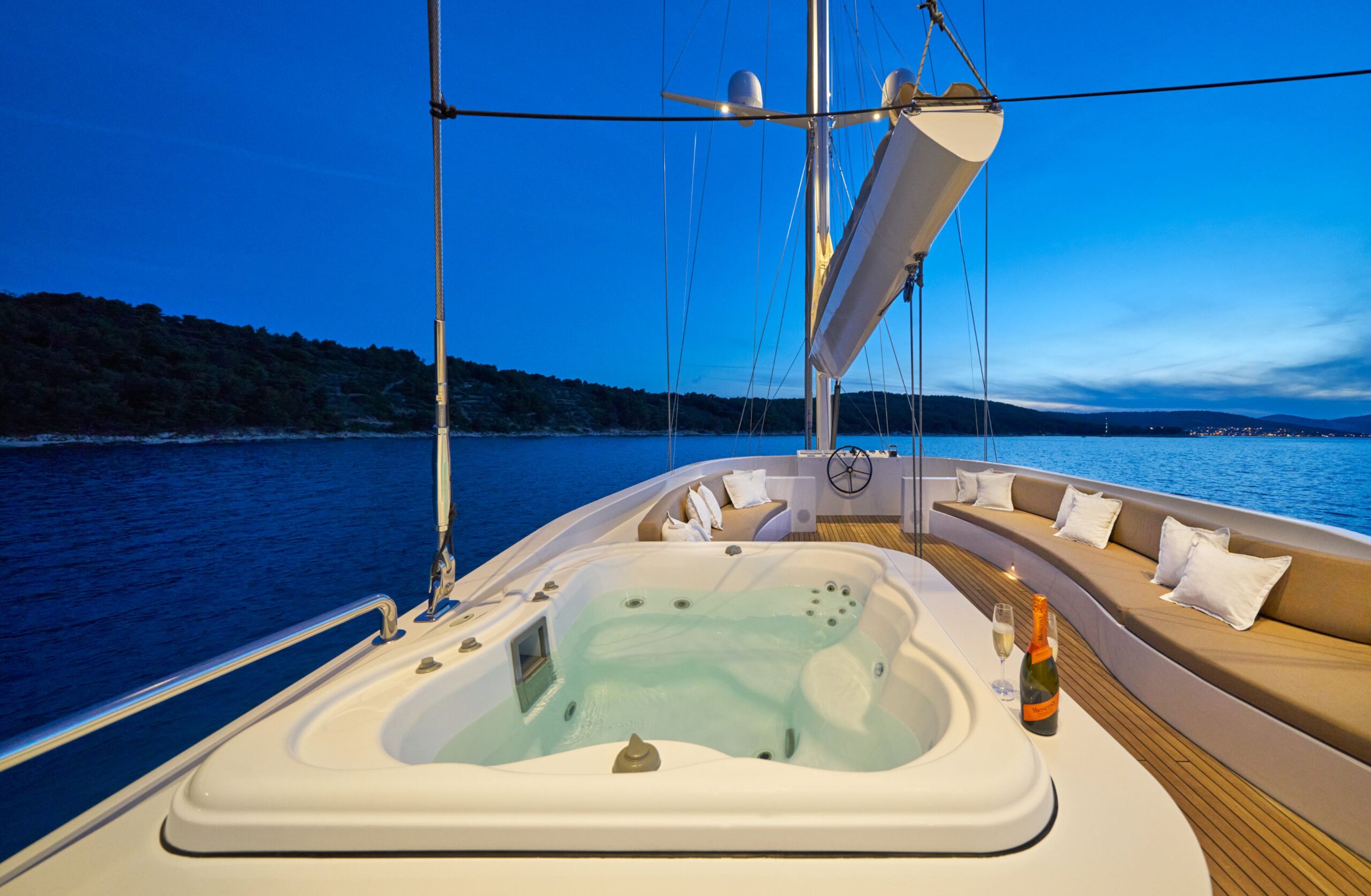 Acapella luxury charter yacht upper-deck jacuzzi, lounge area and a helm with a command bridge