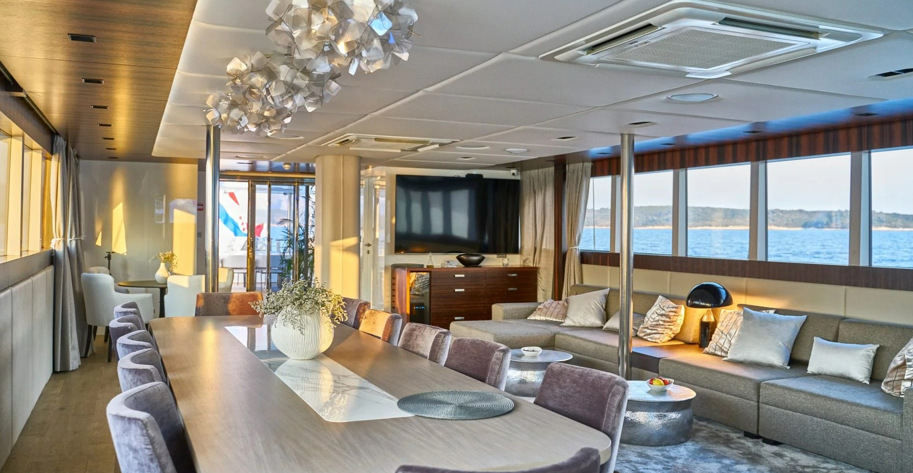 Dalmatino yacht dining and lounge area with TV and big windows