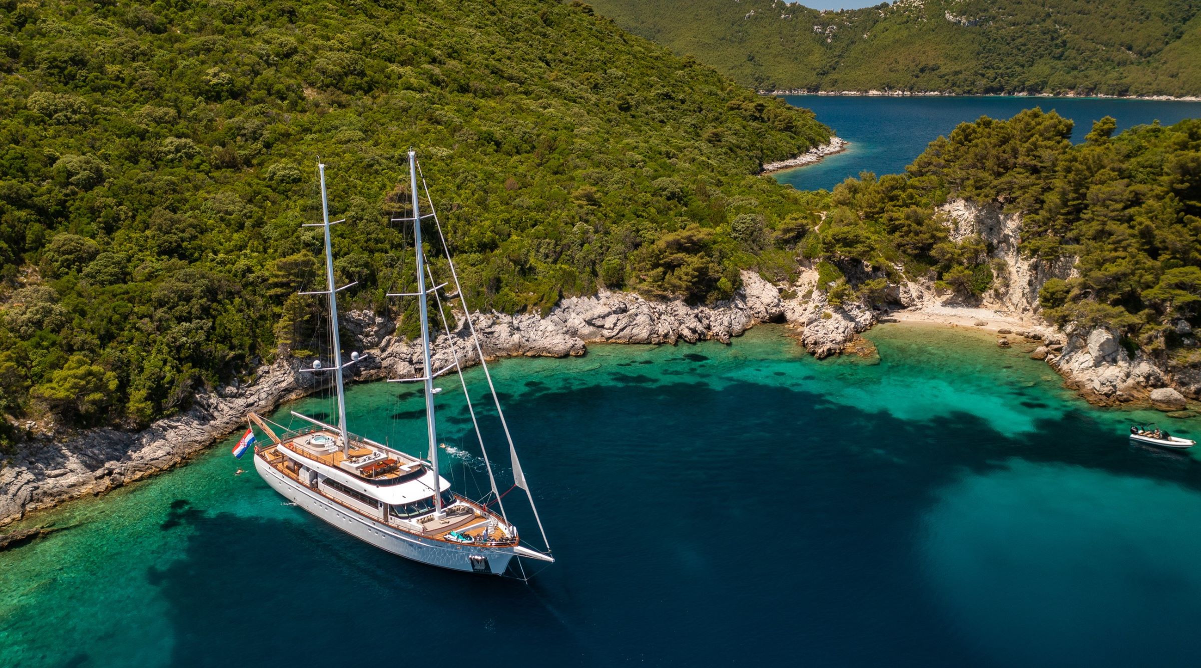 Love Story luxurious sailing yacht anchored near the shore of the Adriatic Sea in Croatia - aerial view.