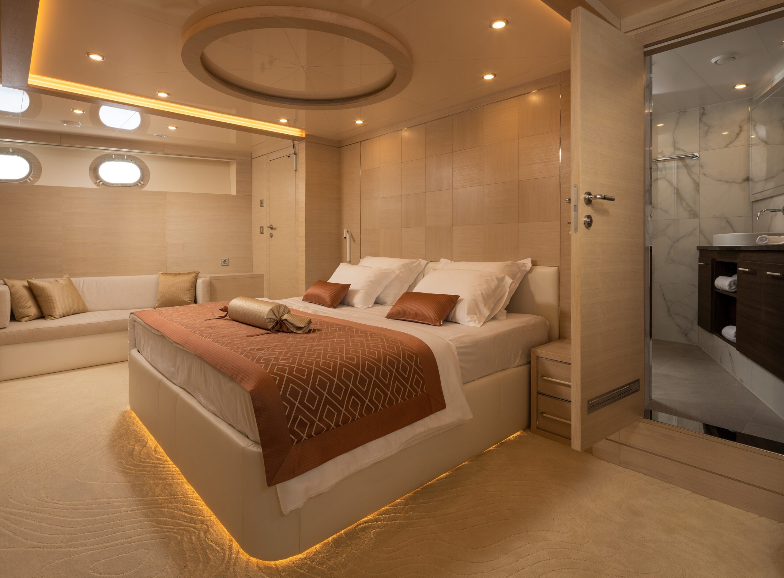 Love Story's luxurious sailing yacht ensuite cabin with double bed, sofa and 2 portholes.