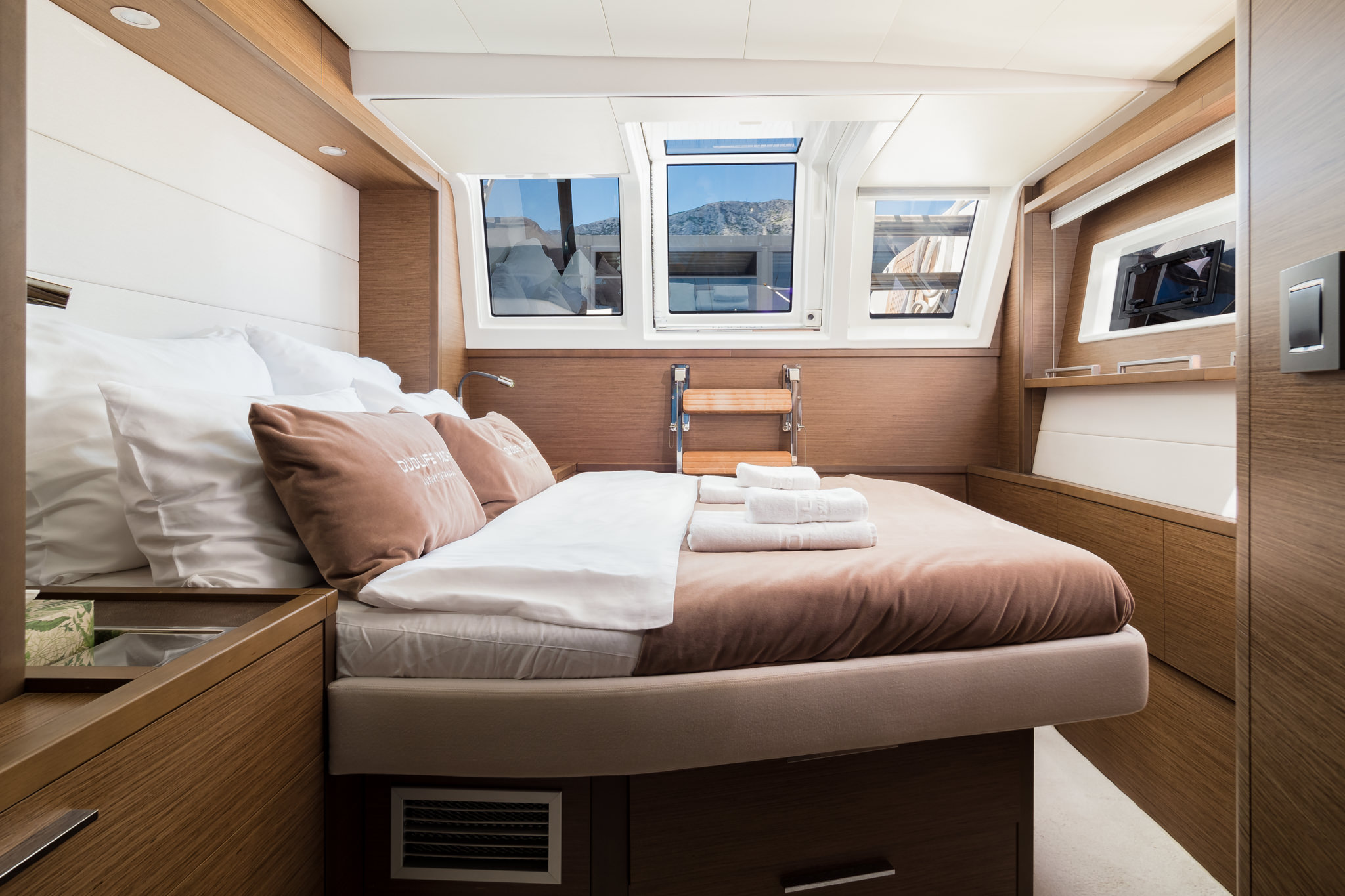 Luxury yacht Duolife catamaran ensuite double bed cabin with 3 big windows and a porthole.