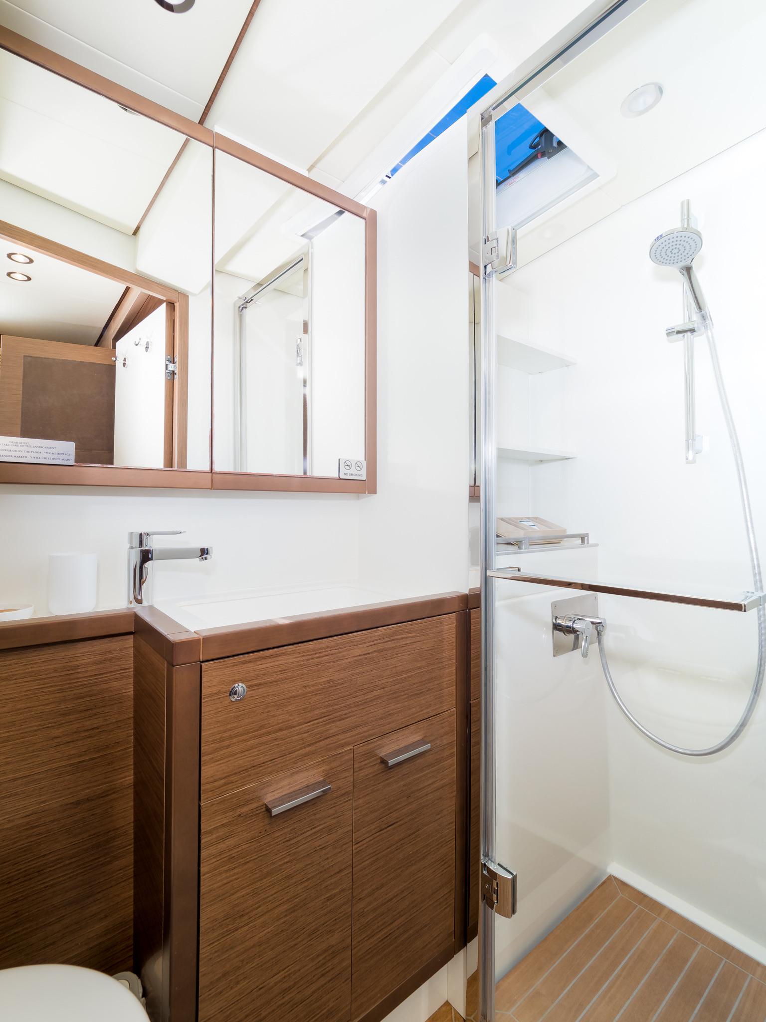 Luxury yacht Duolife catamaran bathroom with a porthole.