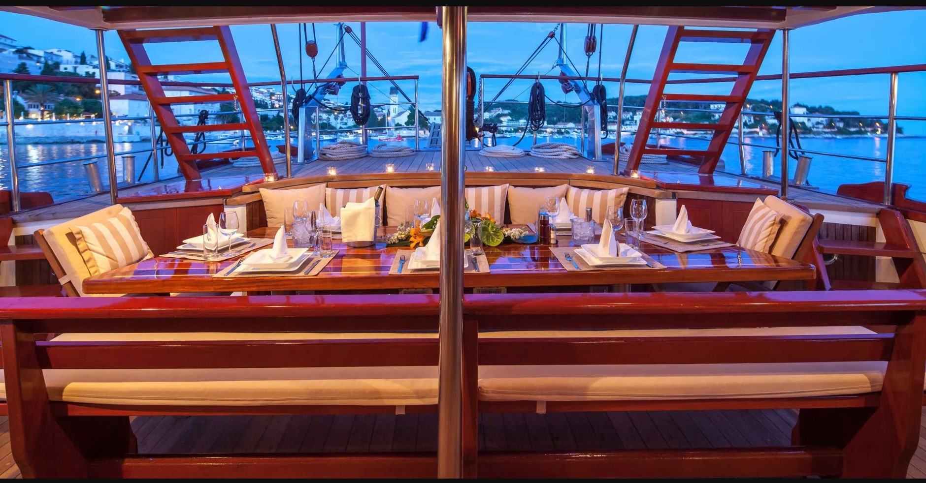 MS ROMANCA yacht covered rear deck with a big table set for dinner