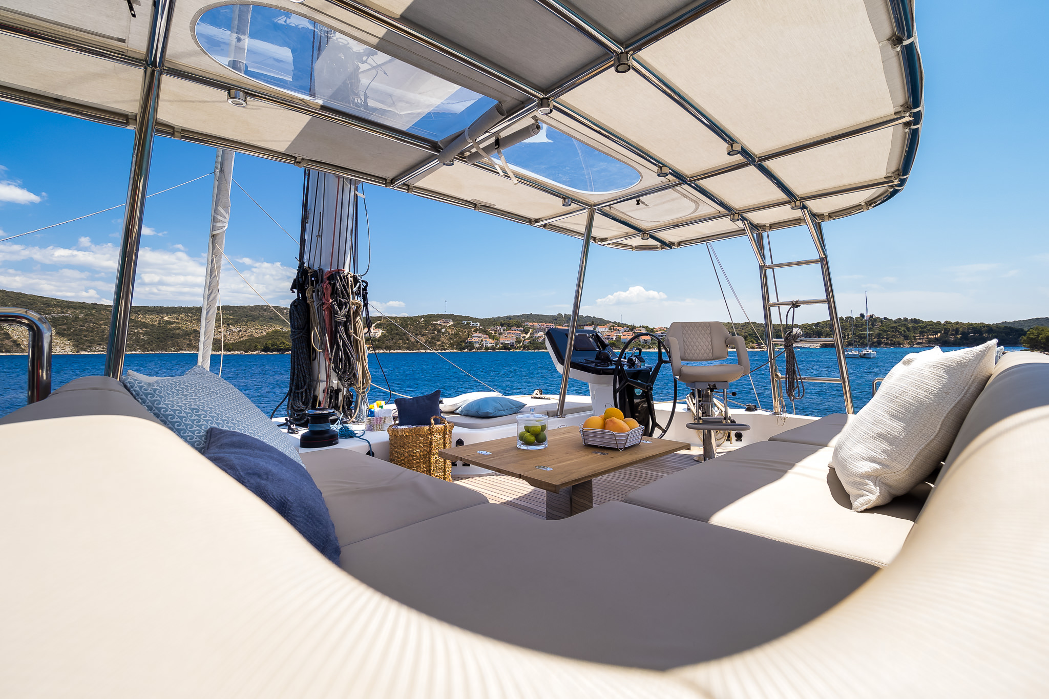 Luxury yacht Solitaire catamaran covered outdoor area with the helm and command bridge area.