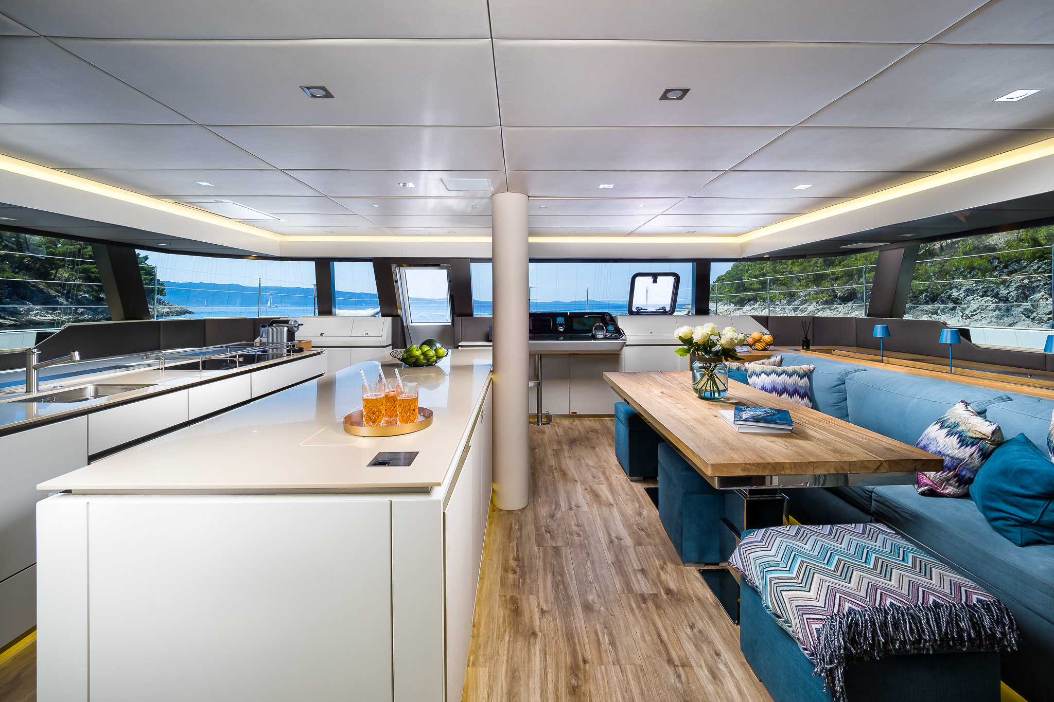 VULPINO luxury yacht catamaran - kitchen area with an island, dining area and a command bridge