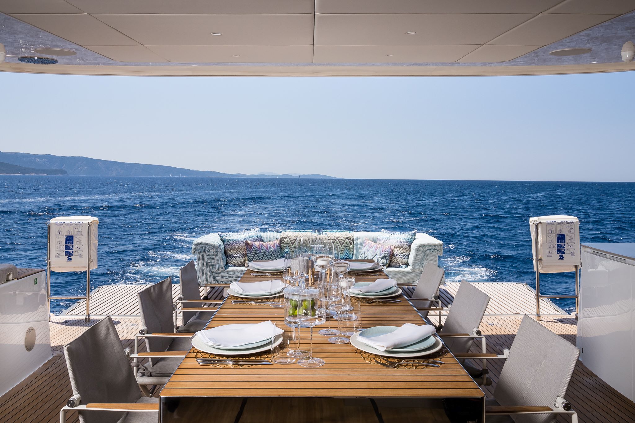 VULPINO luxury yacht catamaran - covered dining area and open lounge area on a stern deck